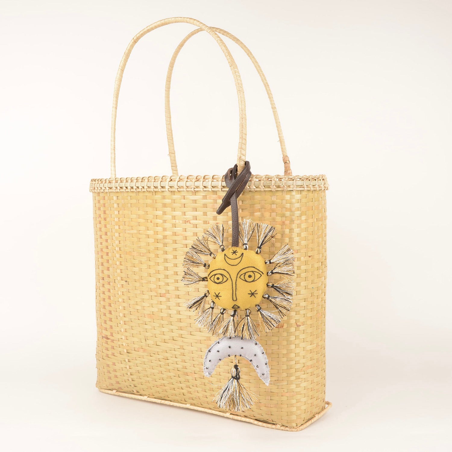 Handcrafted Bag Charm BC_Helios_01 featuring unique fabric design and stylish leather strap, made by Hazara artisans.